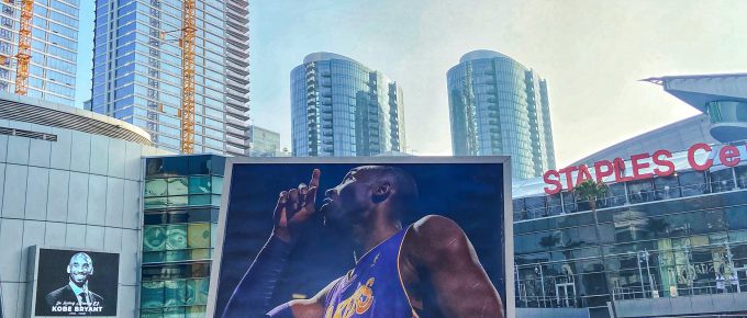 Picture outside the Staples Center of a fan holding a poster of Kobe Bryant
